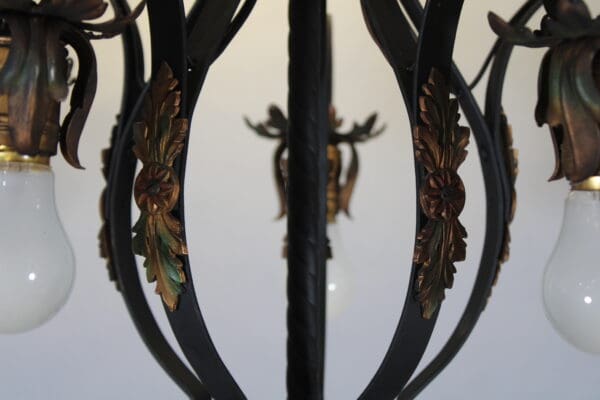 Ornate chandelier with decorative metal leaves.