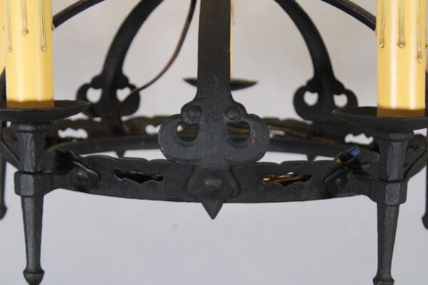 Wrought iron chandelier with candle holders.