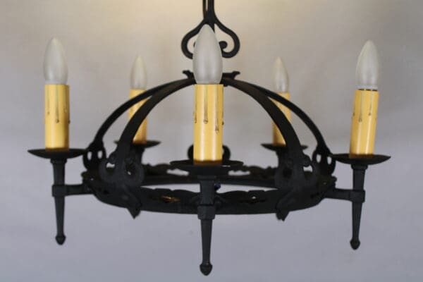 Black wrought iron chandelier with candle lights.