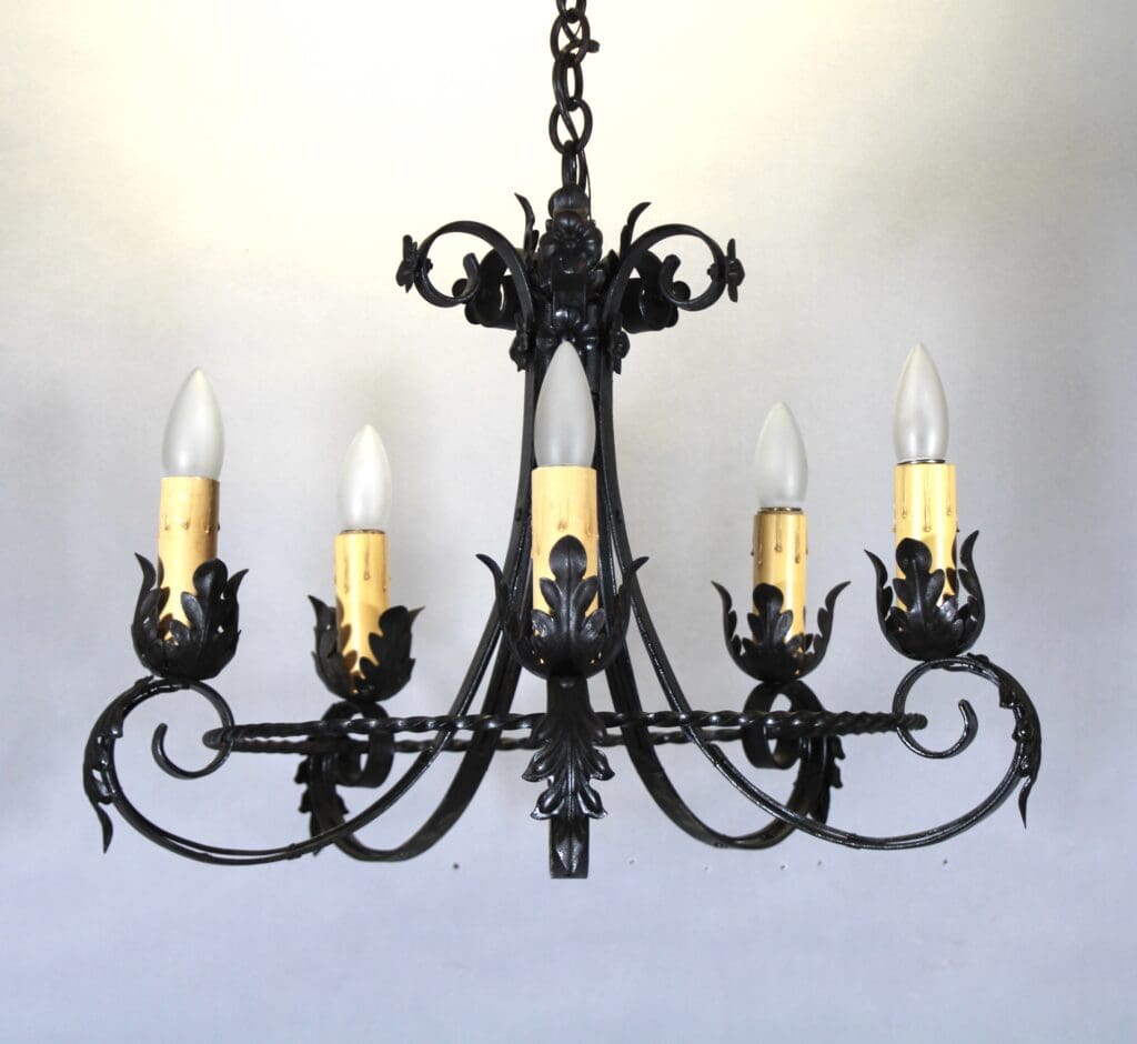 Vintage black wrought iron chandelier with bulbs.
