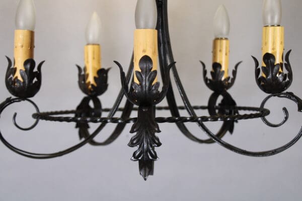 Black wrought iron chandelier with candles.