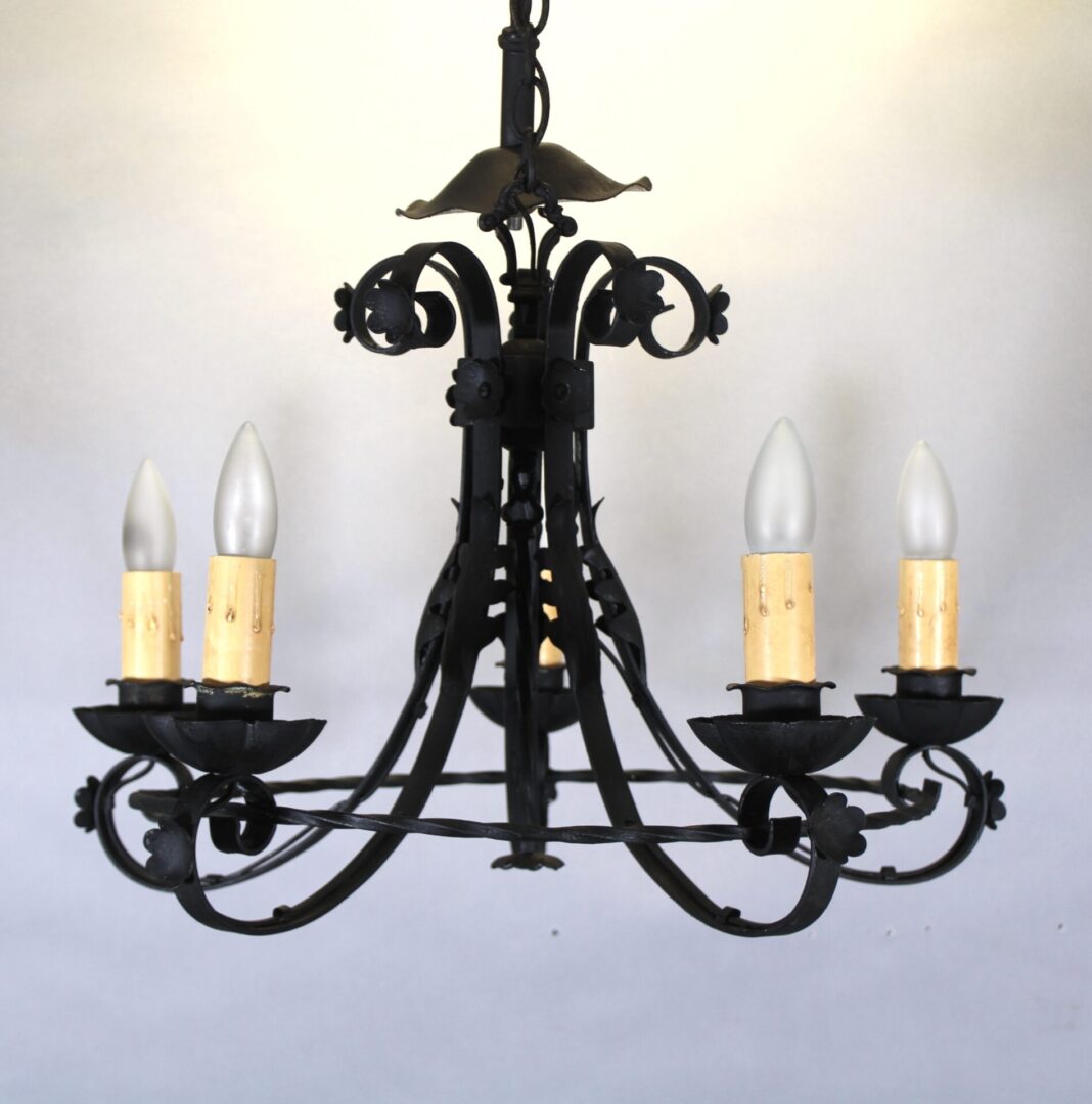 Black wrought iron chandelier with candles.