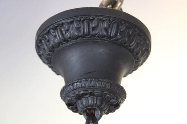 Ornate black chandelier detail with decorative design.