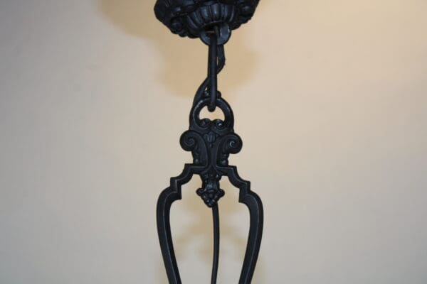 Ornate black metal chandelier detail.
