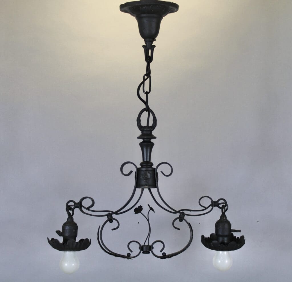 Vintage wrought iron chandelier with two bulbs.
