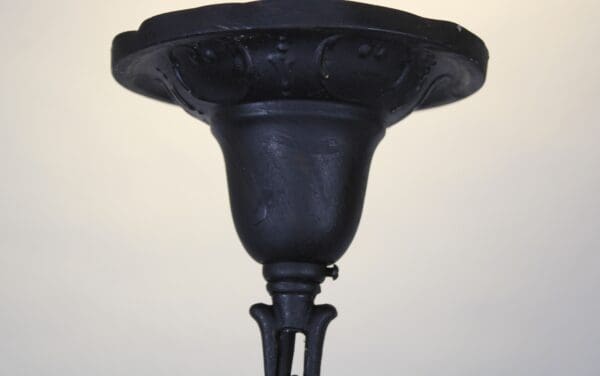 Black metal ceiling light fixture detail.