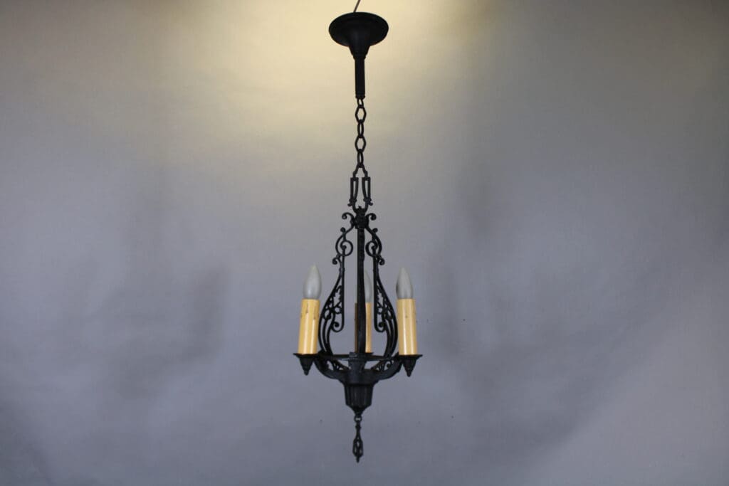 Vintage wrought iron chandelier with candles.