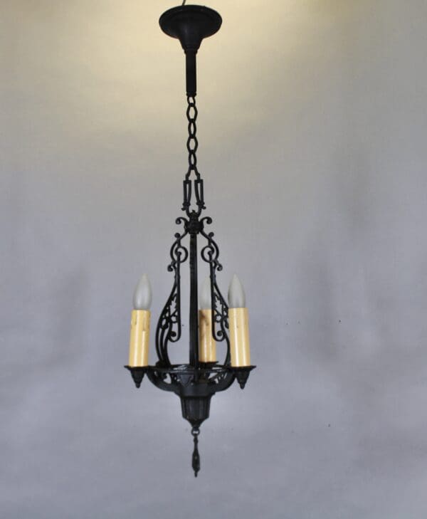 Vintage wrought iron chandelier with candles.