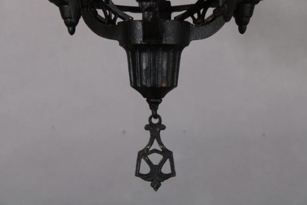 Ornate black metal chandelier detail.
