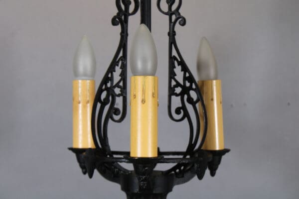 Vintage black iron chandelier with candles.