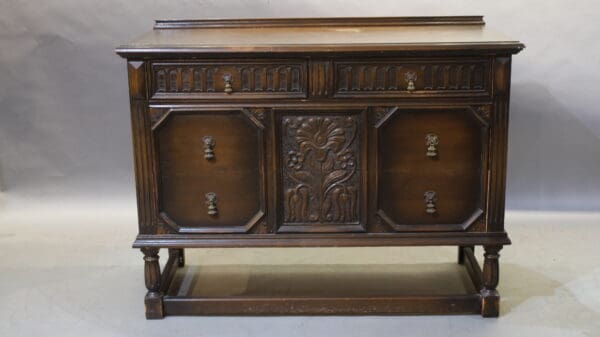 Antique wooden sideboard with ornate carvings.