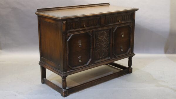 Antique wooden sideboard with ornate drawers.