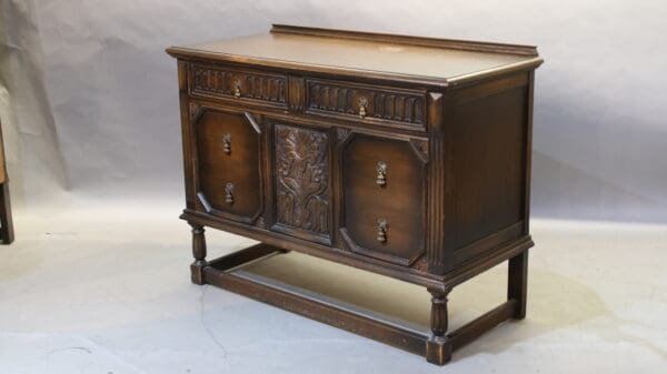 Antique wooden sideboard with carved details.