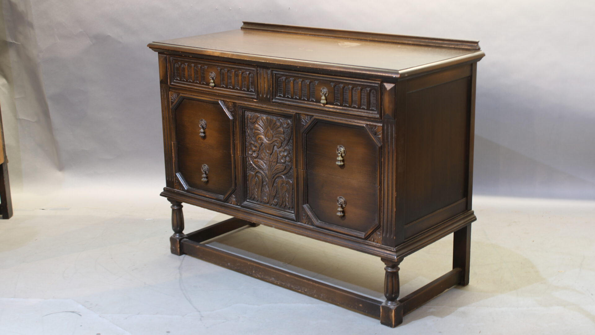 Antique wooden sideboard with carved details.