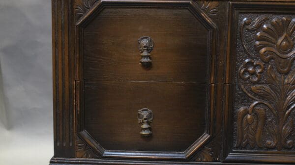 Carved wooden cabinet with ornate details.