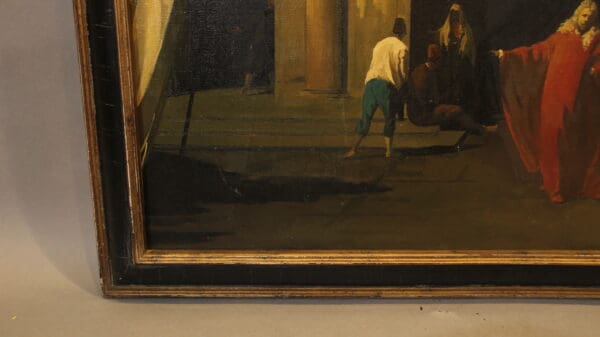 Part of a framed painting with figures.