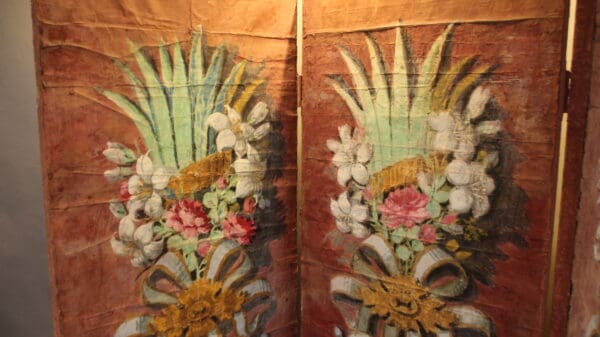 Painted floral design on textured panels.