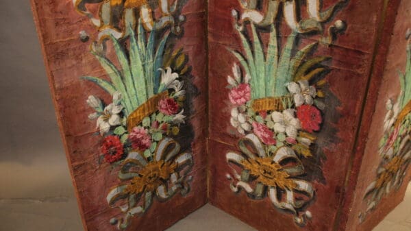 Decorative floral design on wooden panels.