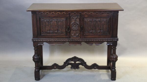Antique wooden sideboard with ornate carvings.