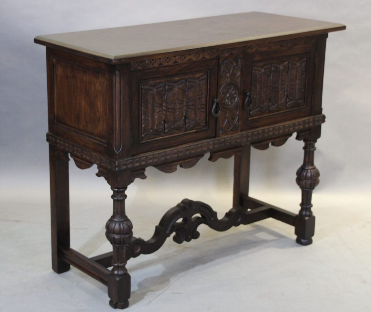 Antique wooden sideboard with ornate carvings.