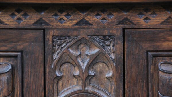 Ornate wooden carving on antique furniture piece.
