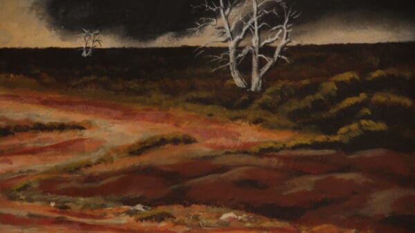 Barren landscape with dark sky and trees.