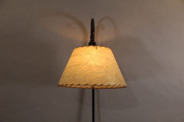 Vintage floor lamp with yellow lampshade.