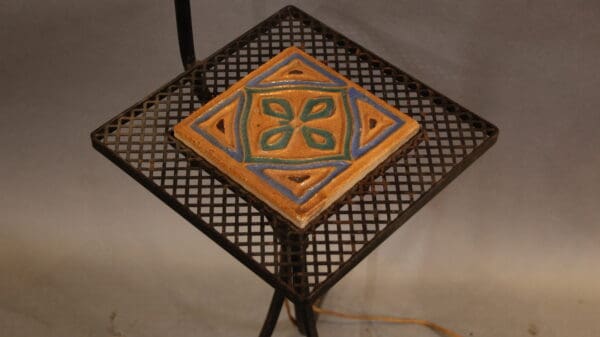 Tile with geometric pattern on metal table.