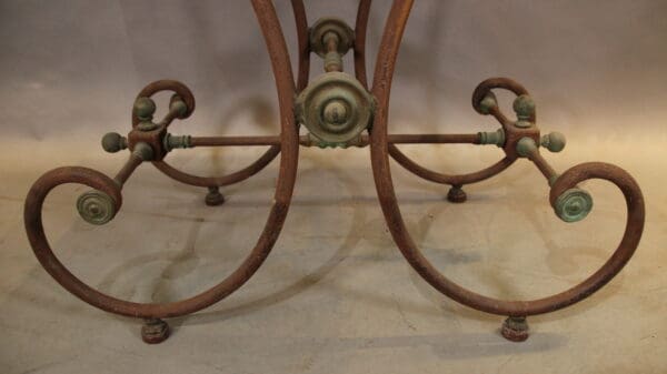 Ornate wrought iron table base design.