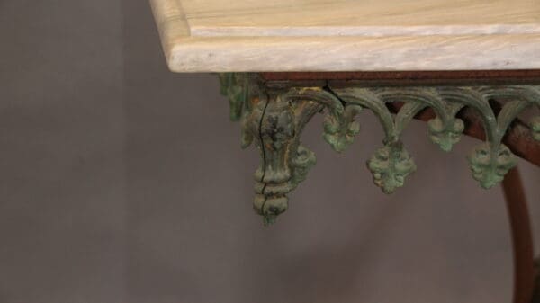 Ornate antique table with decorative green details.