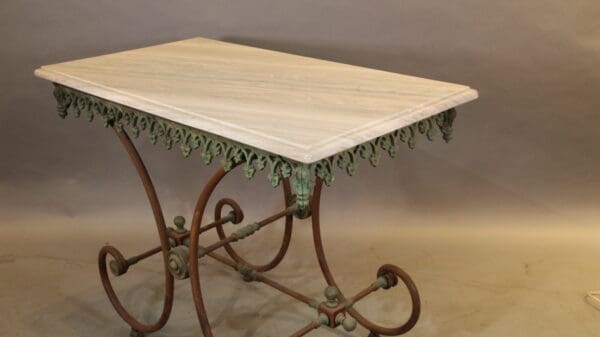 Ornate metal table with decorative legs.