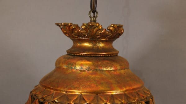 Ornate golden hanging light fixture detail.