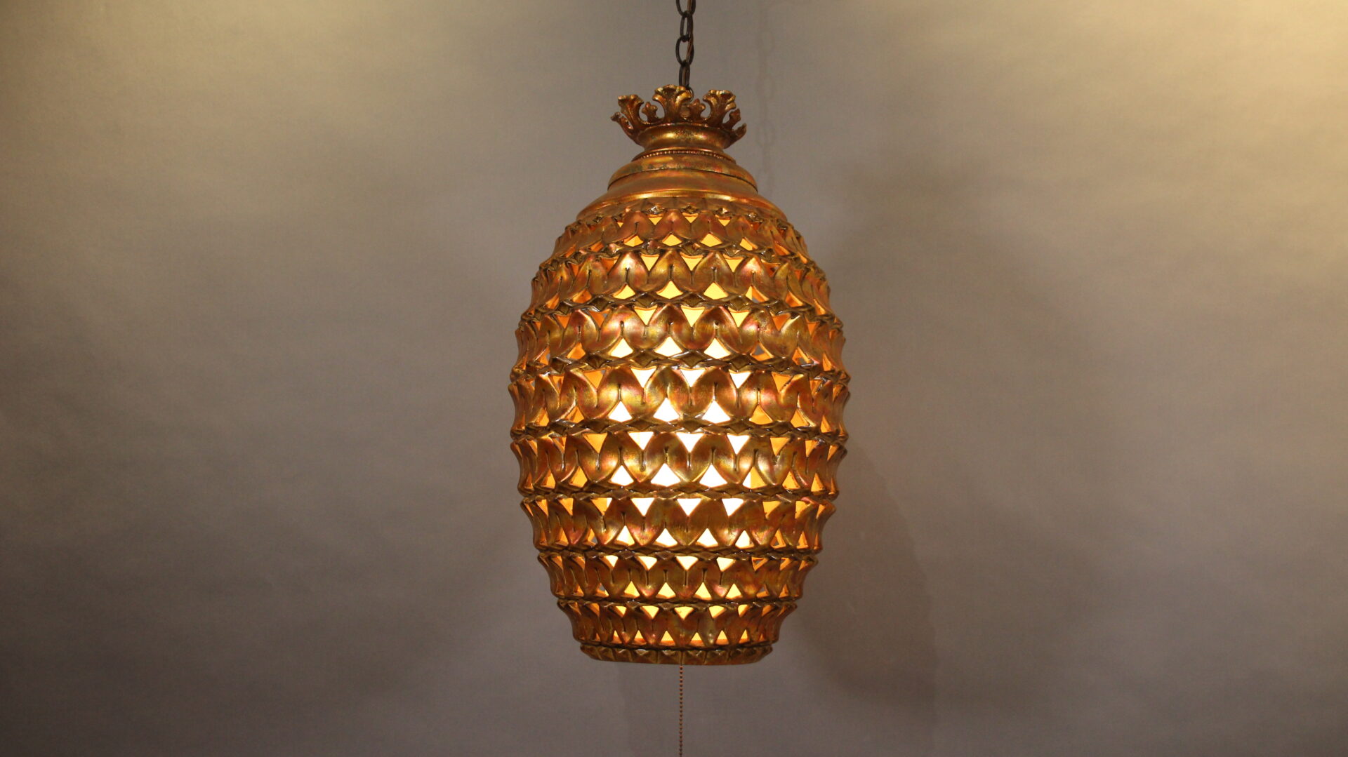 Golden textured hanging pendant light fixture.