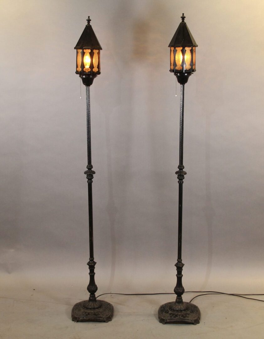 Two vintage floor lamps with warm light.