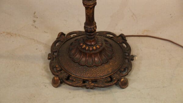Ornate vintage lamp base on white background.