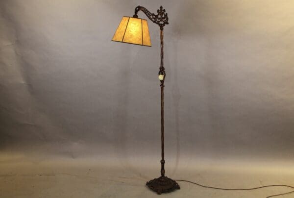 Antique floor lamp with ornate design.