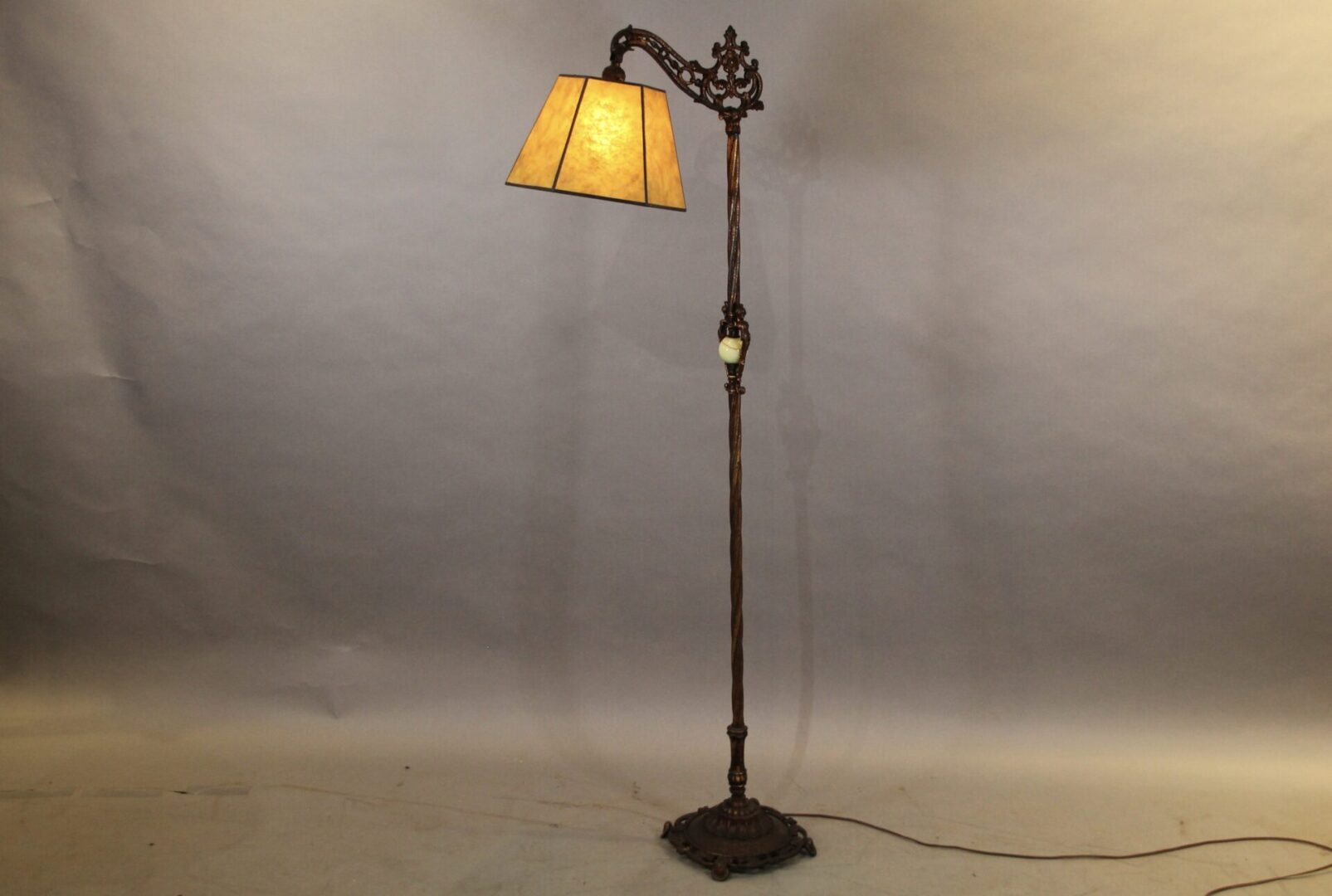 Antique floor lamp with ornate design.