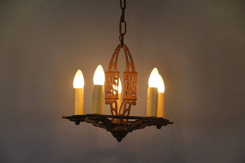 Vintage chandelier with glowing candle bulbs.