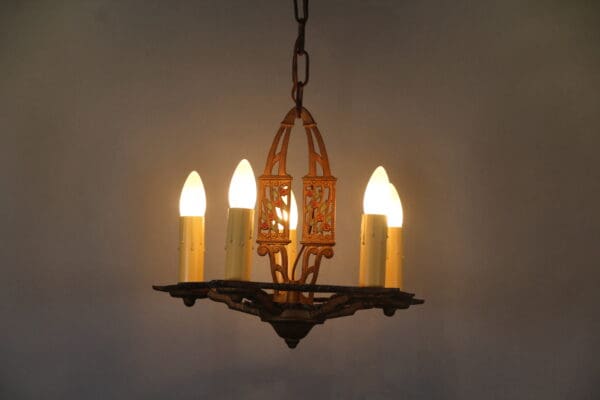 Vintage chandelier with glowing candle bulbs.