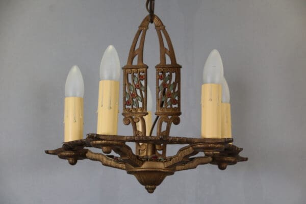 Vintage chandelier with four candle-like bulbs.