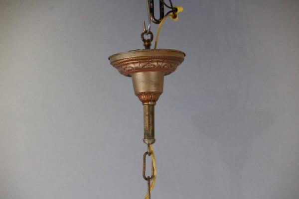 Antique light fixture with decorative details.