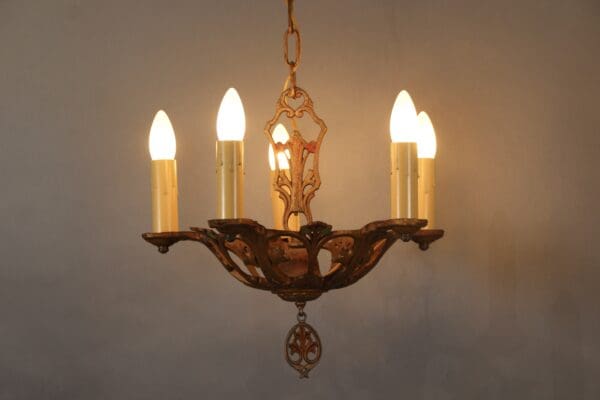 Vintage chandelier with glowing candle bulbs.
