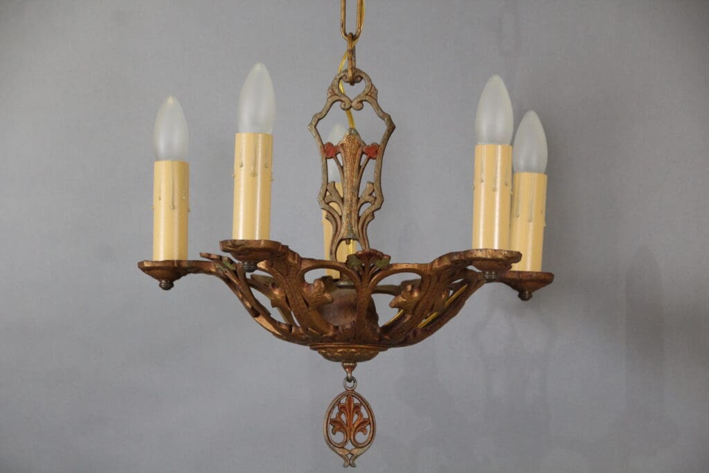 Vintage five-light chandelier with ornate design.