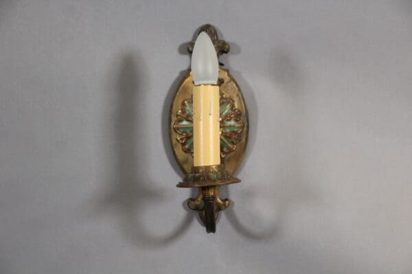 Vintage wall sconce with decorative design.