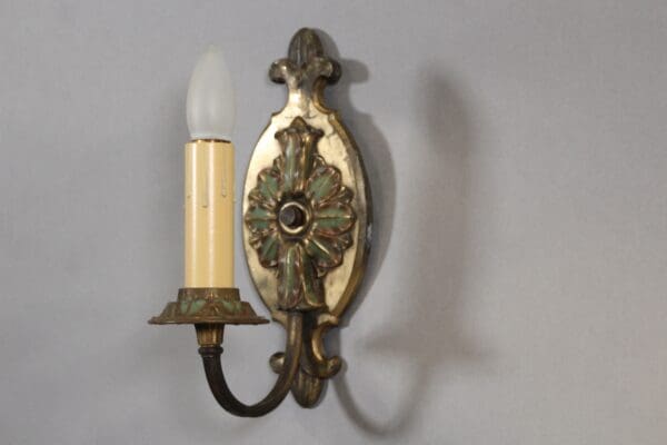 Vintage brass wall sconce with bulb.