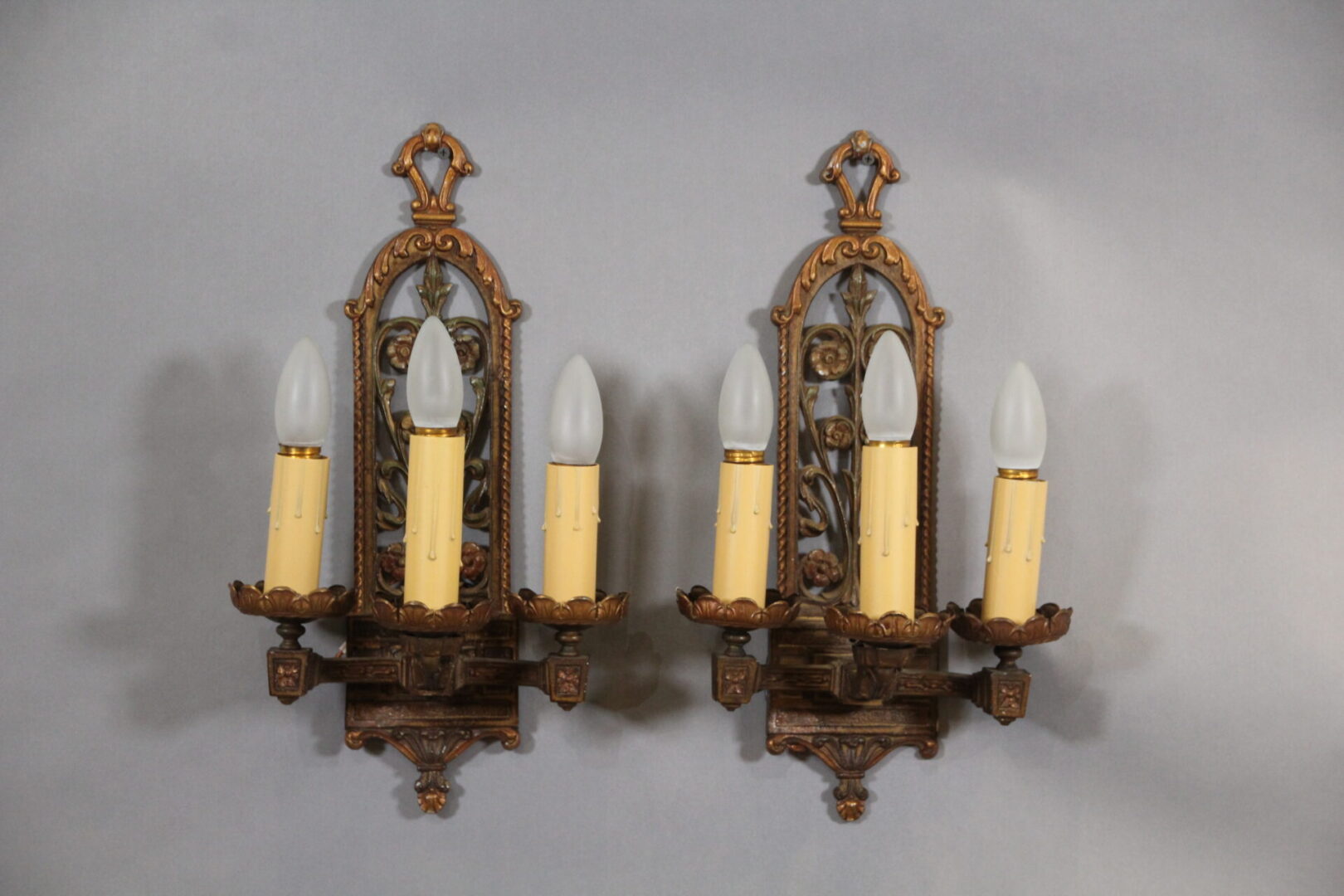 Vintage wall sconces with candle-shaped bulbs.