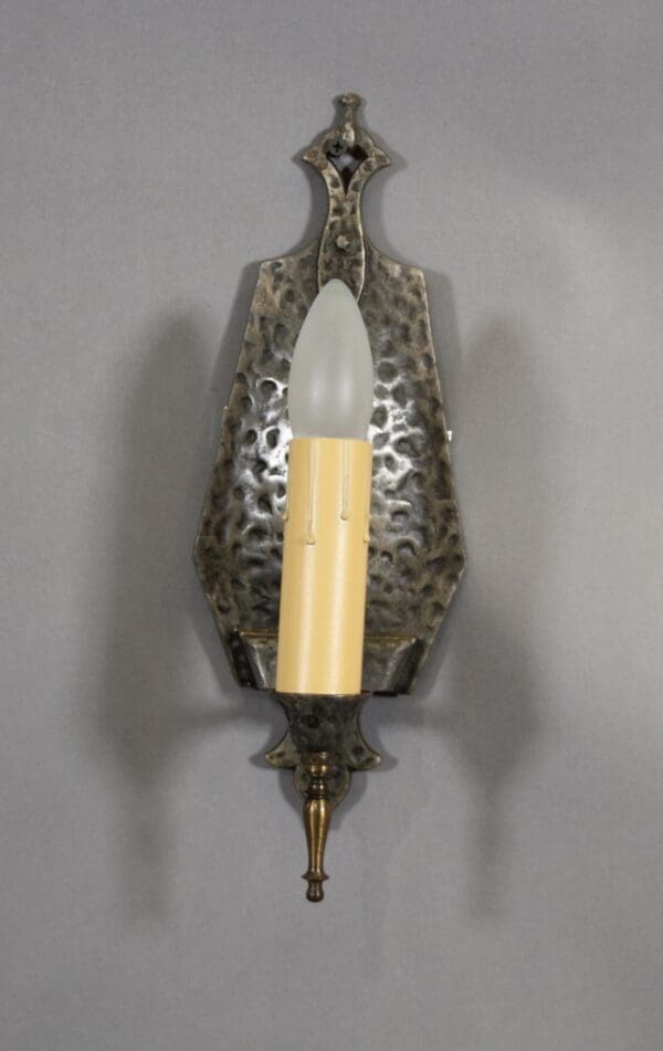 Wall sconce with candle-like bulb.