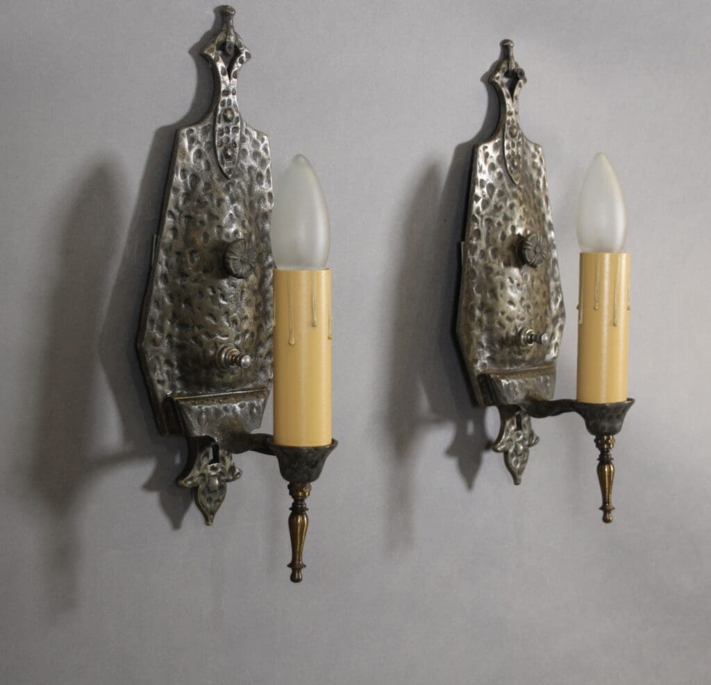 Antique wall sconces with candle-shaped bulbs.