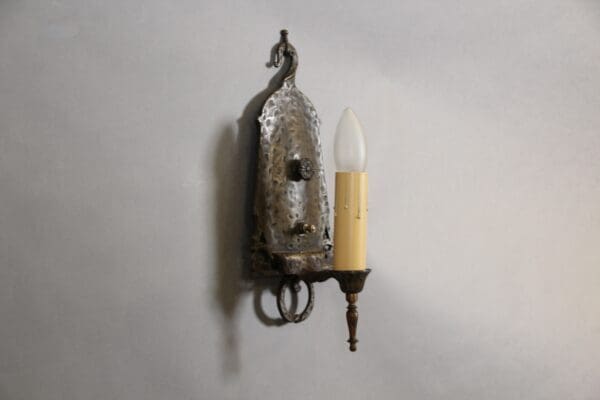 Vintage metal wall sconce with light bulb.