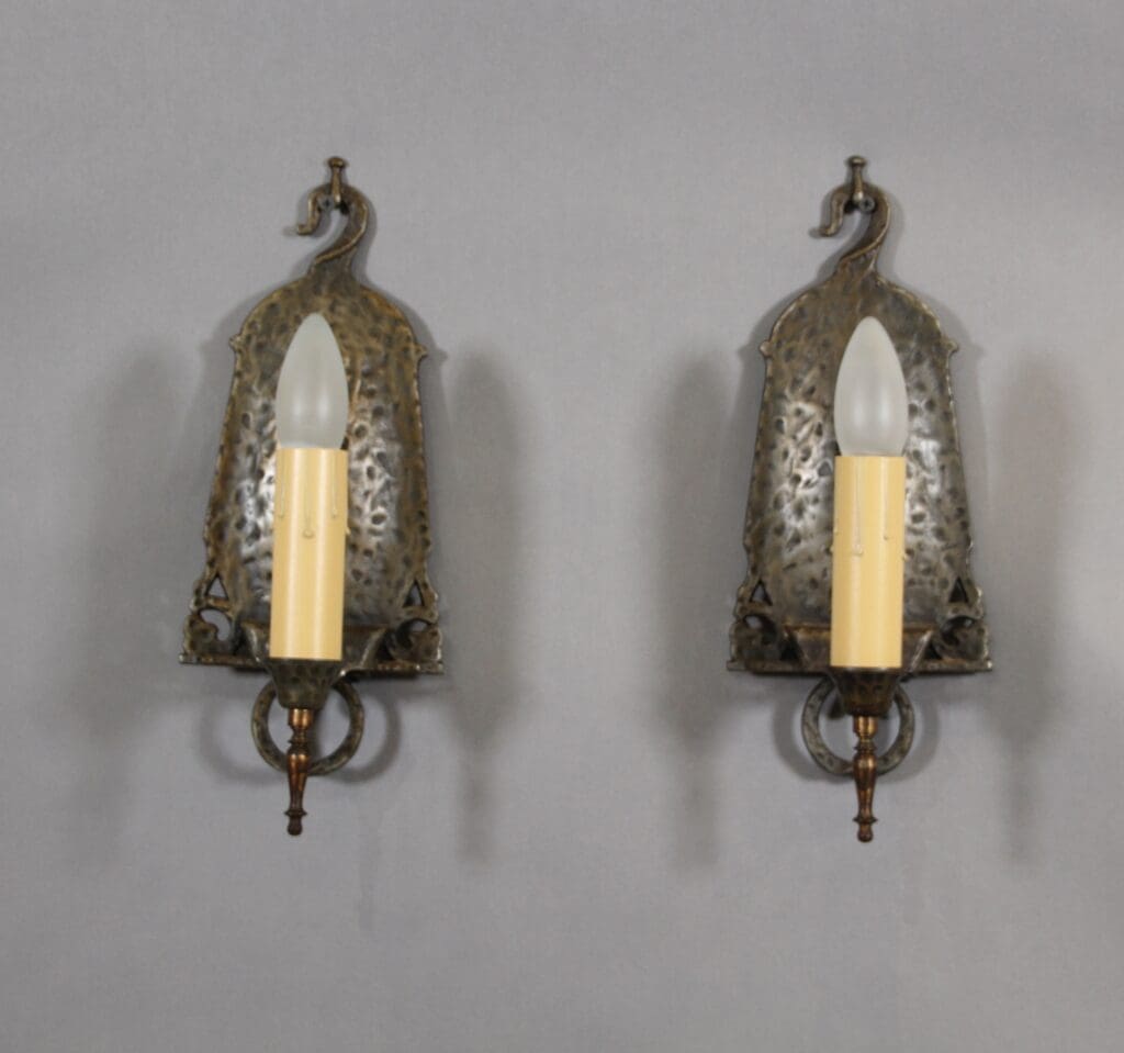 Two ornate wall sconces with candle bulbs.